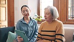 Tablet, discussion and woman with senior mother in living room networking on social media. Conversation, relax and young female person explaining digital technology to elderly mom in lounge at home.