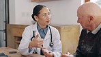 Woman, doctor and consulting elderly patient on medication for prescription or diagnosis at old age home. Female person, surgeon or medical professional talking to senior man on pills for healthcare