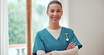 Woman, arms crossed and face of nurse working in living room of nursing home. Happy, caregiver and portrait with confident healthcare worker with pride for career in retirement care service or house