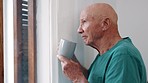 Senior man, window and memory with coffee, ideas or vision with peace, mindfulness or perspective. Elderly person, home and thinking with drink for decision, choice or planning retirement in home