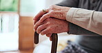 Hands, walking stick and a senior couple closeup for love, support or trust in the bedroom of a home together. Empathy, medical or healthcare with an elderly man and woman bonding in their apartment