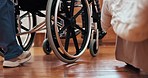 Doctor, nurse and patient with legs in wheelchair for assistance, help or support in home. Medical professional, service and person with a disability for injury, rehabilitation or care in bedroom