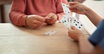 Nursing home, hands and playing cards by nurse and elderly man for dementia, memory loss or gambling. Senior care, poker and old patient with homecare worker for Alzheimer, cognitive or assessment