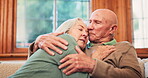 Trust, support and hug with a senior couple on a sofa in the living room of their retirement home together. Safety, love and comfort with an elderly man embracing his wife to console her during loss