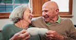 Old couple, tea and love care in retirement home for connection, pensioner relax together or morning kiss. Man, woman and hot drink on sofa trust support communication, marriage calm or happy peace
