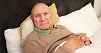 Elderly, man and unhappy for health in bedroom with news, diagnosis or result in home for patient care. Senior person, face and lying for rest on pillow for no, head and shake for worry in retirement