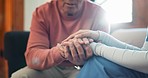 Nurse, holding hands and care in support, trust or healthcare for understanding on living room sofa at home. Closeup of people touching in grief, loss or kindness for nursing or elderly care at house