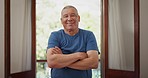 Face, smile and senior man with arms crossed in home, living room or apartment for retirement. Portrait, happy elderly person and confidence in house, healthy teeth or wellness of pensioner in Mexico