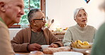 Tea party, elderly friends and visit with people in a retirement home together for bonding in the morning. Smile, conversation and a community of happy seniors in the living room of an apartment