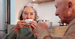 Tea party, elderly couple and funny with people in a retirement home together for bonding in the morning. Smile, drink and happy seniors laughing ay a joke in the living room of an apartment