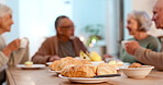 Breakfast, food and senior friends in home for bonding, conversation and social relationship at dinner table. Retirement, talking and mature people with bread for meal, brunch and eating together