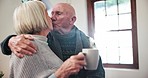 Kiss, senior couple and coffee in home, love and bonding together in morning in winter. Romance, elderly man and woman with tea cup, drink and healthy relationship, connection and hug for support