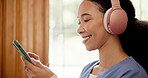 Nurse, headphones and woman with a smartphone, typing and smile with connection, streaming music and internet. Person, medical and professional with headset, cellphone and radio with audio and sound