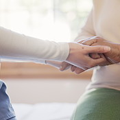 Physiotherapist, holding hands and closeup for support in clinic with ...