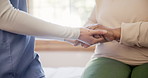 Physiotherapist, holding hands and closeup for support in clinic with care, empathy and kindness on bed. Doctor, nurse and consultation for rehabilitation, recovery and healthcare in room at hospital