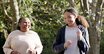 Happy woman, coach and running with senior for exercise, workout or outdoor training together at park. Active personal trainer run with mature female person for sports motivation, health and wellness