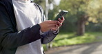 Hands, smartphone and texting in park, exercise and morning for communication, online and typing. Person, social media and tracking steps in sportswear, outdoor and active with cellphone fitness app