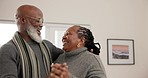 Elderly African couple, dancing and smile in home, holding hands and laugh for moving together with comic memory. Senior man, black woman dancer and happy with steps, playful and bonding with love