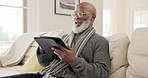 Senior man, tablet and laugh in home for reading news app, social media post or ebook in lounge. Elderly african guy relax to scroll funny digital blog, online shopping or download meme in retirement