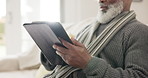 Old man, tablet and scroll reading in home for entertainment, internet connection or article. Black male person, touch screen and hands closeup or information search, online web or social network