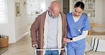 Woman, nurse and helping elderly man walk in living room with walker at old age home. Female person, nurse or medical caregiver with senior patient in support, nursing or healthcare at house