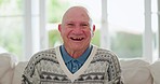 Face, funny and senior man on sofa in home living room, lounge or apartment for retirement. Portrait, laughing elderly person on couch and relax in house, smile or happiness of pensioner in Australia