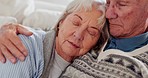 Love, happy and senior couple hugging on a sofa in the living room for comfort and bonding together. Care, romance and elderly man in retirement embracing his wife in the lounge of modern home.