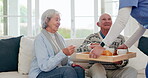 Senior man, woman or caregiver for serve coffee on sofa, support or care in nursing home. Elderly couple, nurse and tea for wellness, peace and zen for healthcare trust, help and happy in living room