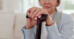 Cane, hands and senior woman on sofa in living room for retirement in house. Walking stick, couch and closeup of elderly person with a disability, crutch for injury and support, help and osteoporosis