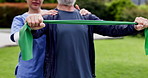 Physiotherapist, senior man and resistance band for fitness, training or motivation for wellness. Nurse, elderly patient and support for rehabilitation in garden, outdoor or park for health in nature