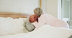 Senior, couple and kiss forehead in bed for support, sick and conversation with retirement or healing. People, man and woman in bedroom with communication, empathy and love for trust, care and rest