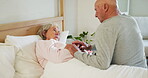 Senior, couple and holding hands in bed for support, sick and conversation with retirement or healing. People, man and woman in bedroom with communication, empathy and love for trust, care and rest