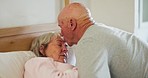 Senior, couple and kiss on face in home for comfort, romance or care in marriage on retirement. Elderly man, woman and together for quality, time and bonding in bedroom with trust, support or love