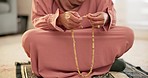 Islamic, beads or hands of woman in prayer to God in faith, devotion or worship for Eid or ramadan. Counting closeup, muslim or Arabic person on carpet in home for fasting, reflection or wellness