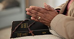 Rosary, bible or hands of person praying for faith, studying religion or help in holy spiritual scripture. Christian literature, closeup or worship book for education on God or Jesus Christ in home