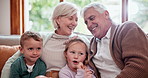 Smile, love and children with grandparents on a sofa in the living room at modern home. Happy, bonding and young kids embracing senior man and woman in retirement with care in the lounge of house.