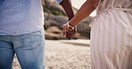 Love, couple holding hands at beach and trust in romantic connection, healthy relationship and bonding on holiday. Closeup, man and woman with support at ocean, back at sea and care on date in summer