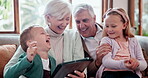 Children, grandparents and tablet on sofa for games playing, talking or laughing conversation. Girl, boy and elderly couple for online connection or social media in digital streaming, movies or funny