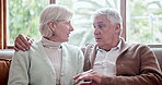 Hug, home and senior couple on a sofa, love and retirement with romance, relationship and happiness. Apartment, elderly man or old woman on a couch, embrace and romantic with marriage or conversation