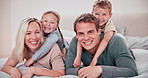 Smile, love and face of family on a bed relaxing, bonding and hugging in the morning at home. Happy, embracing and children laying or resting with parents in bedroom together on a weekend in a house.