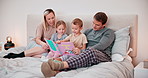 Parents, kids and reading books in bed for learning, language development or literature for knowledge. Mother, father and relax with happy children at bedtime, storytelling or together in family home