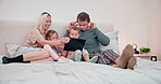 Parents, kids and tablet on bed for selfie, social media and update profile picture online at home. Mom, dad and happy family of children relax for funny digital photography, memory or smile together