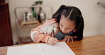 Girl, child and writing in book for education, learning or homework on desk at house. Little kid, female person or teen drawing or sketching in notebook for creative development or homeschool at home