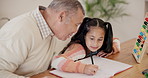 Grandfather, grandchild and writing homework with helping, talking and learning for education at dining table. Family, senior man and girl child with homeschooling, communication and care at home