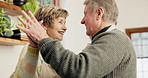 Old couple, dancing and kitchen love in house for romance tango, retirement together or cooking dinner. Senior people, happy and moving to music for connection smile, support on weekend vacation joy