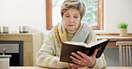 Senior, woman and reading bible in home for prayer, faith and worship Jesus Christ, holy spirit or God. Christian lady, gospel and books for knowledge, praise spiritual religion or hope in retirement