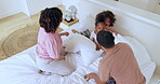 Parents, children and pillow fight in bed in morning, playing and care to love together. Mom, dad or kids for funny game with talking, bonding in above bedroom or happy family at home to connect 


