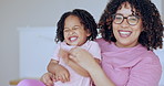 Family, love and a mother tickling her daughter in the bedroom of their home together for bonding. Portrait, smile or funny with a happy young parent and girl child laughing or having fun in bed