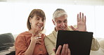 Tablet, wave and video call with a senior couple on a sofa in the living room of their apartment together. Technology, smile or virtual communication with a happy elderly man and woman talking online