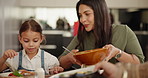 Eating, food and child with mother at dinner, celebration or together for meal with dish and support. Girl, mom and sharing buffet on plate in dining room at brunch with vegetables or salad in home